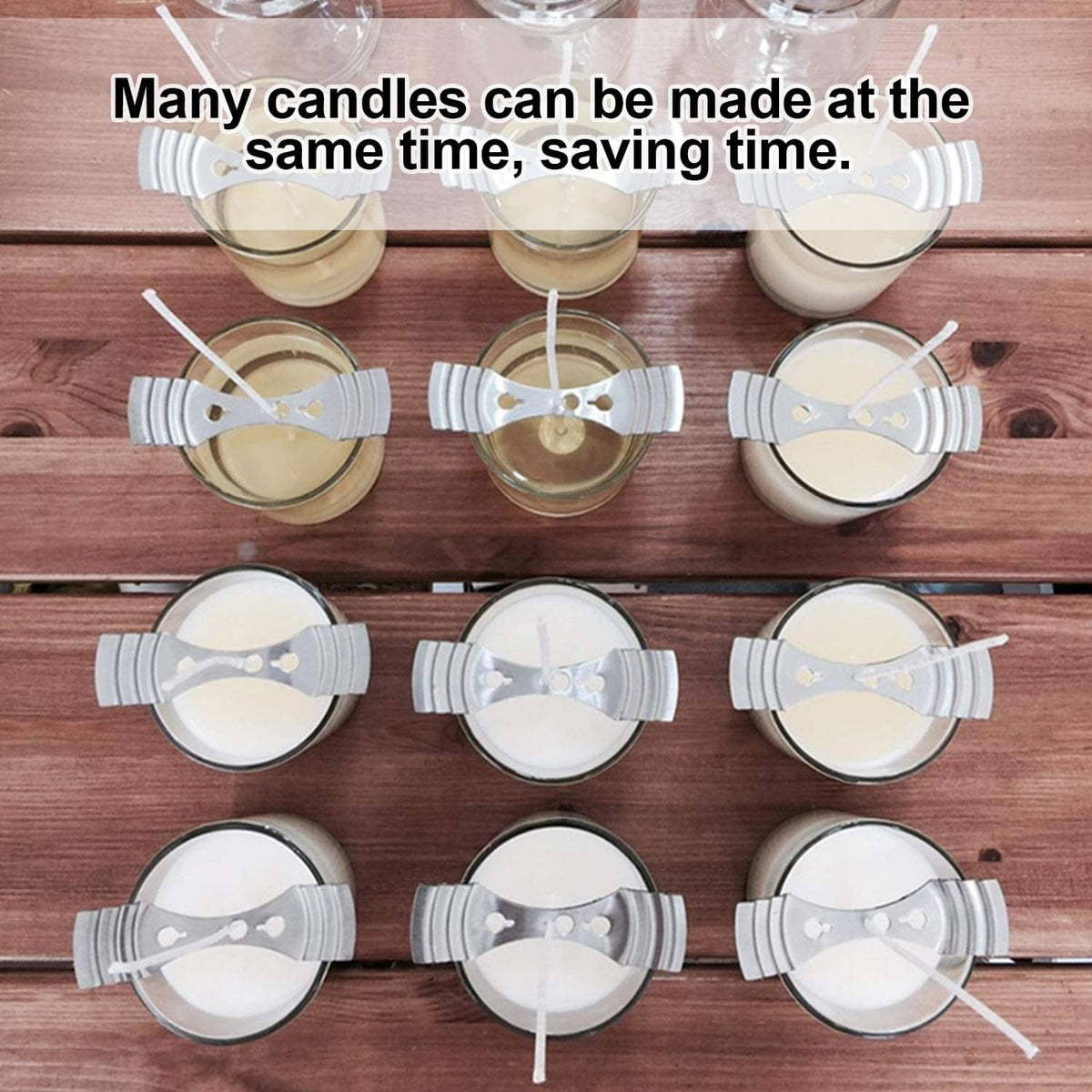 Silver wick centering clips on multiple small candles arranged on a wooden surface