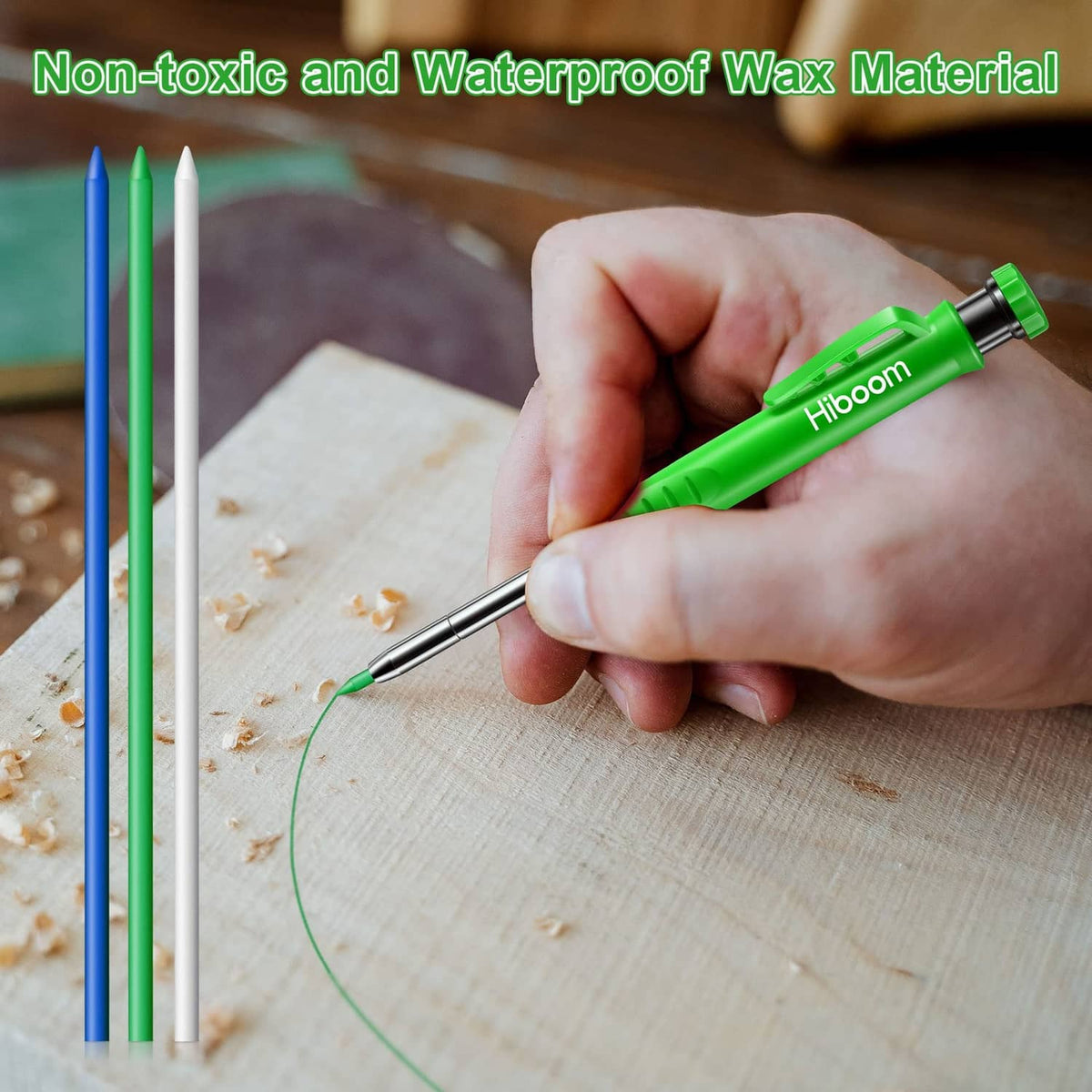 Hand holding a green pencil refill with blue and green refills on light wood