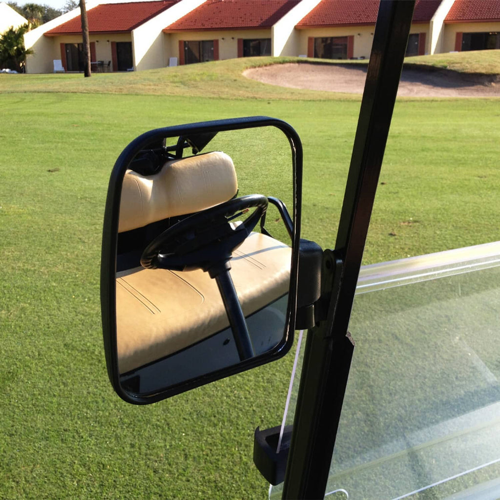 Golf cart side mirror with black frame and convex lens on outdoor cart