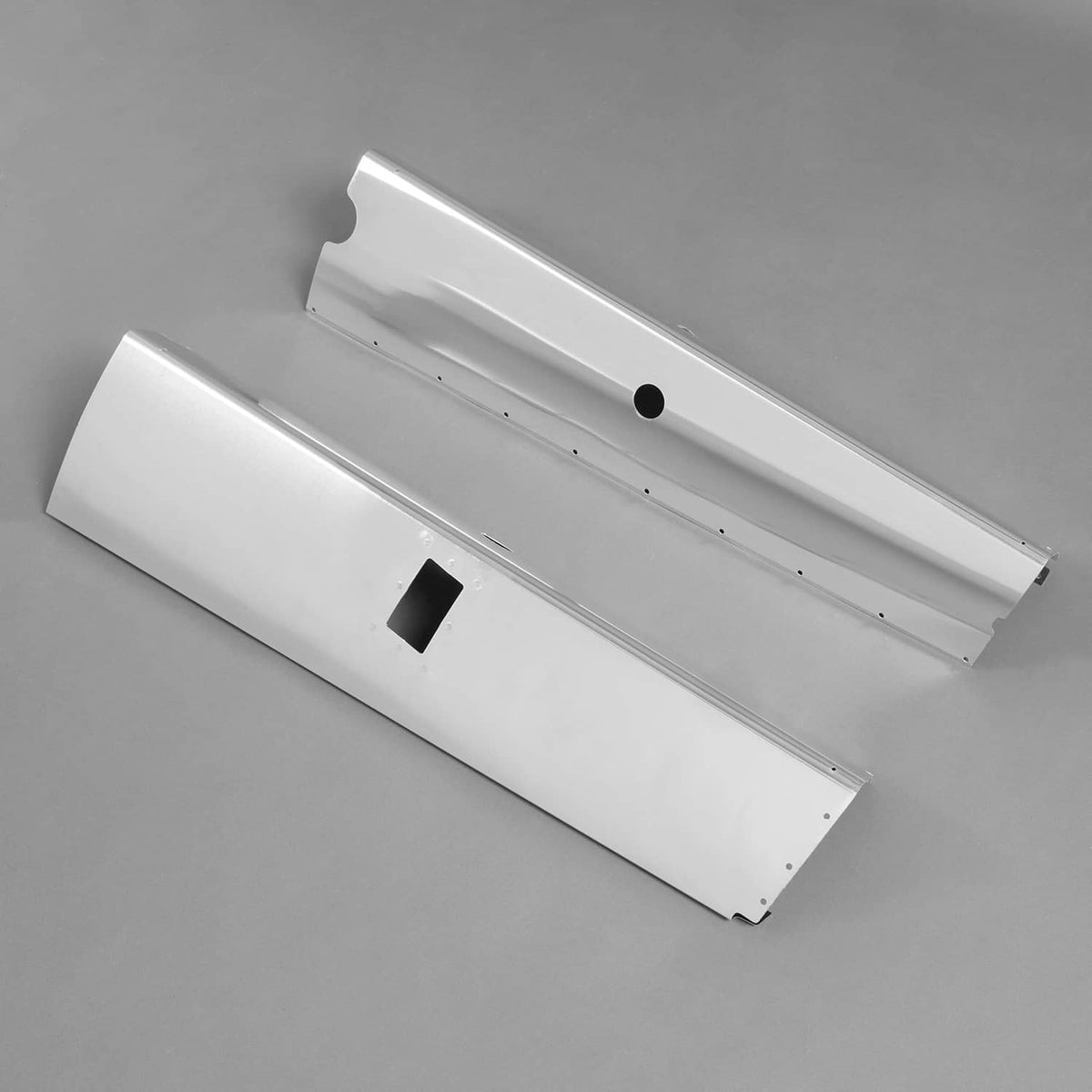 Silvery aluminum landing gear fairing panels set with rectangular openings and fastener holes