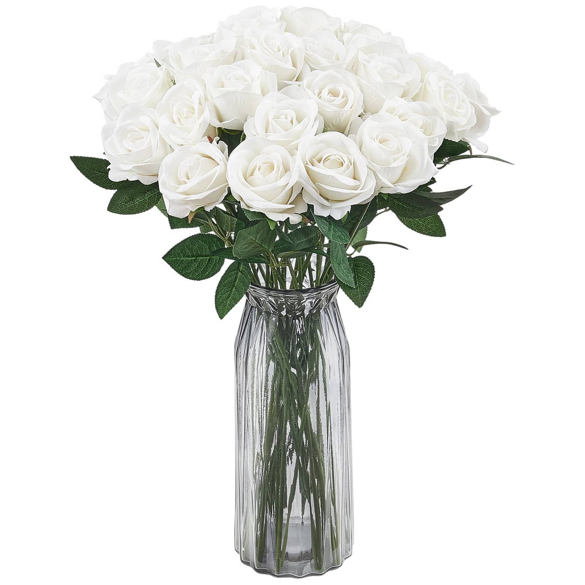 Artificial white rose bouquet with green leaves in a clear glass vase