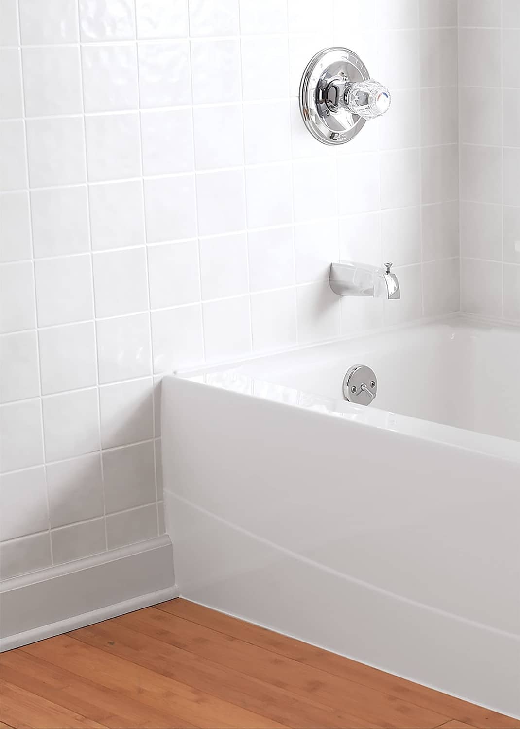 Gloss white tub and tile finish on corner bathtub with shower fixtures