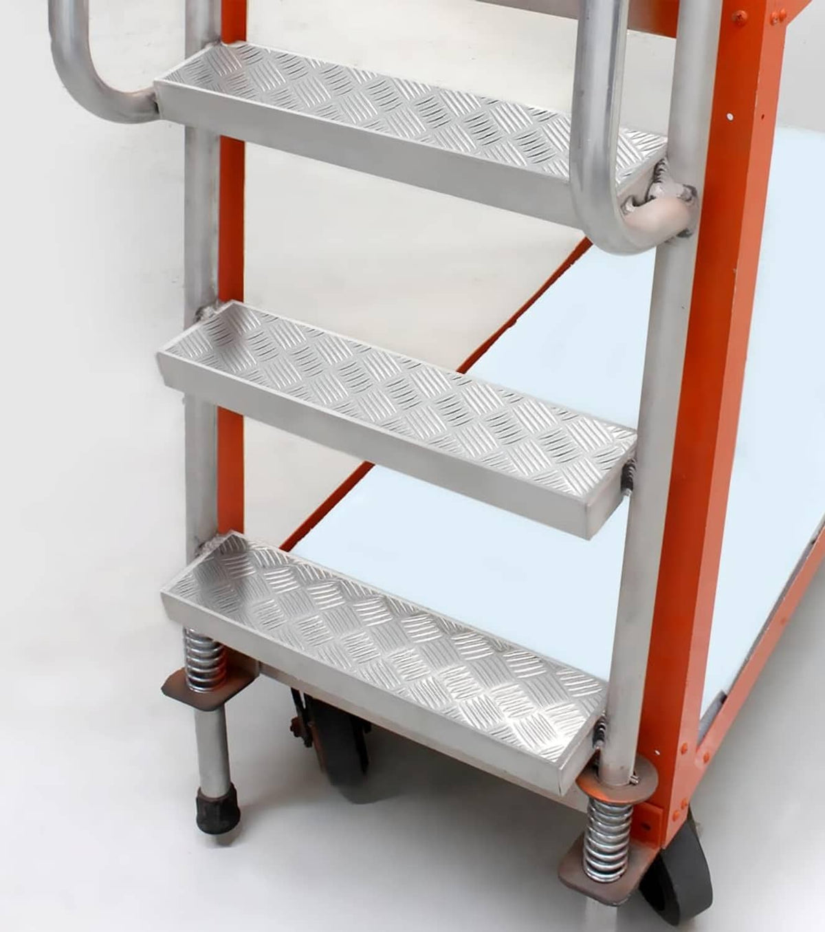 Diamond-plate metallic chrome vinyl wrap stairs on an orange ladder frame