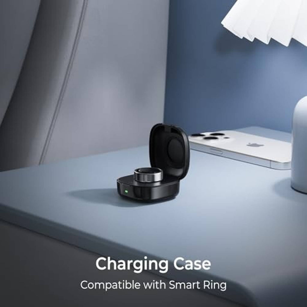 Black wireless charging case with open lid and metal charging dock on tabletop