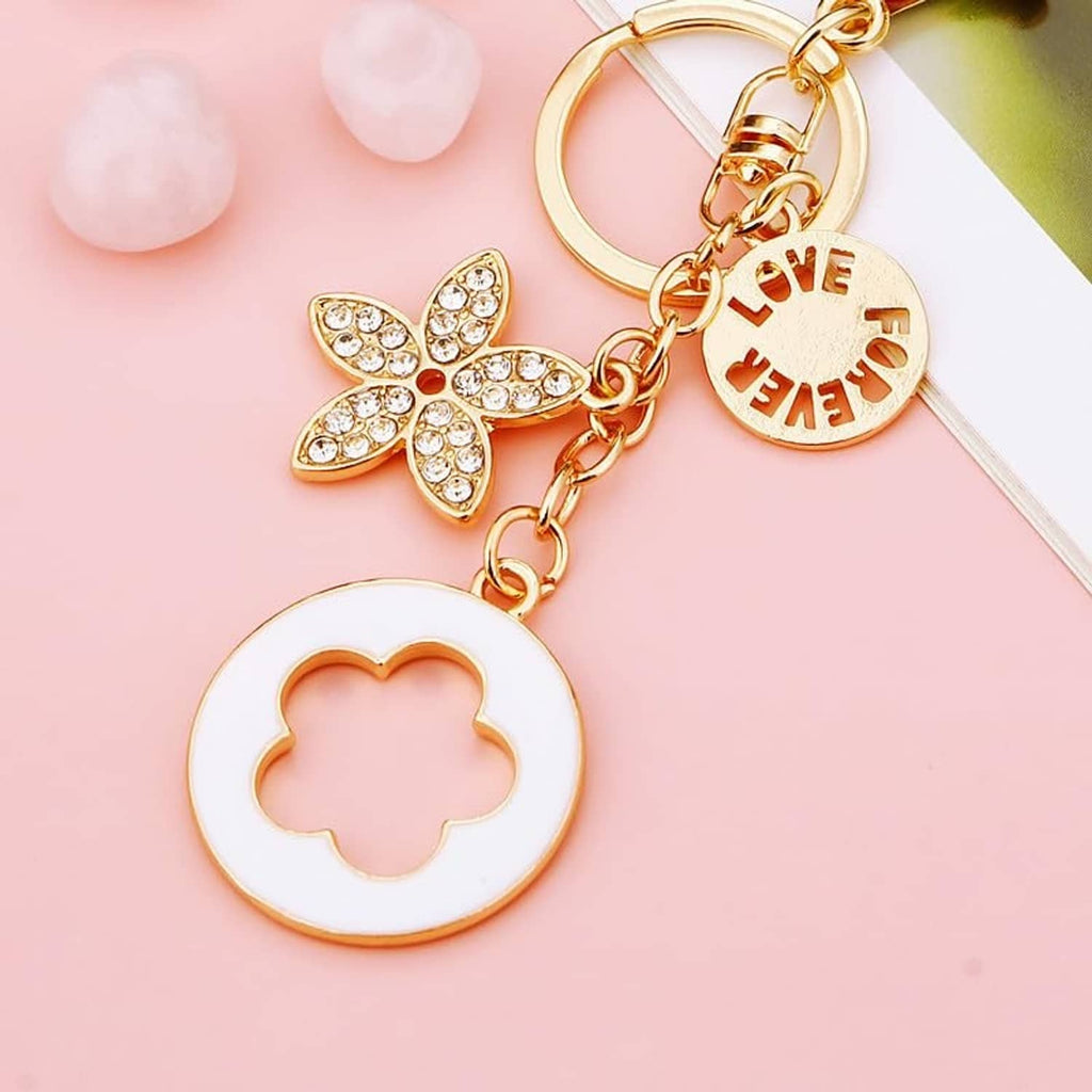 Keychain charm set in gold and white with butterfly and flower shapes