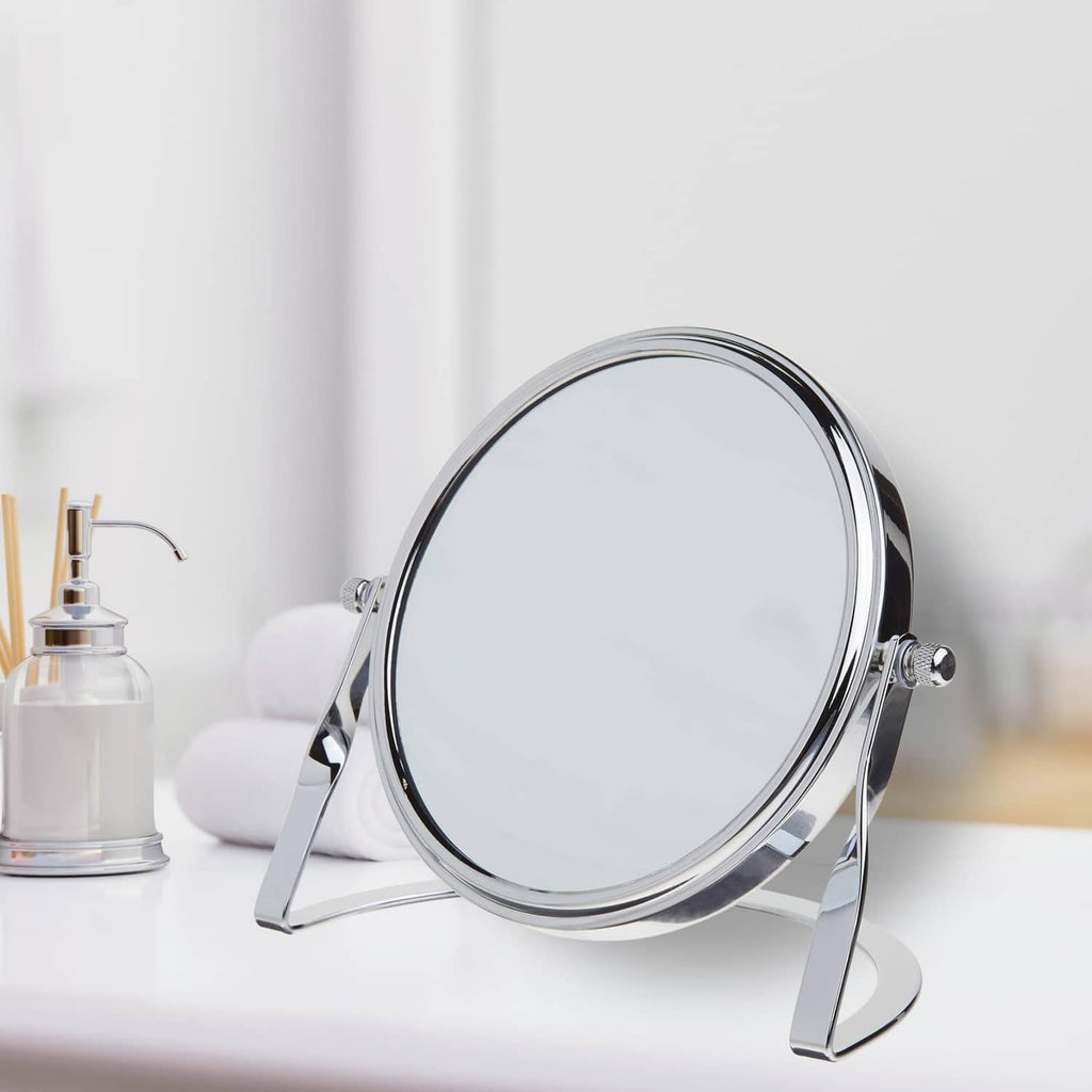 Round chrome tabletop vanity mirror on folding stand with side adjustment knobs