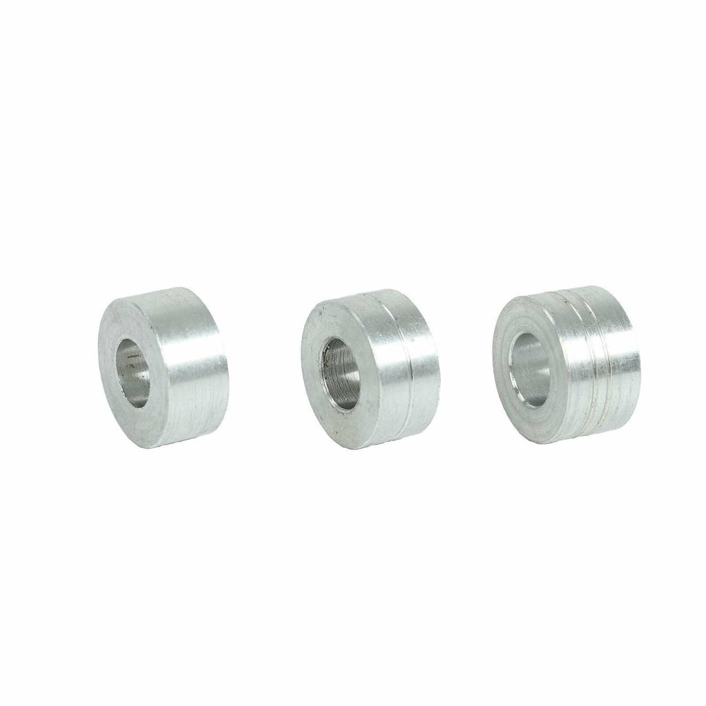 Three silver cylindrical spacers/bushings with inner hole, metal construction