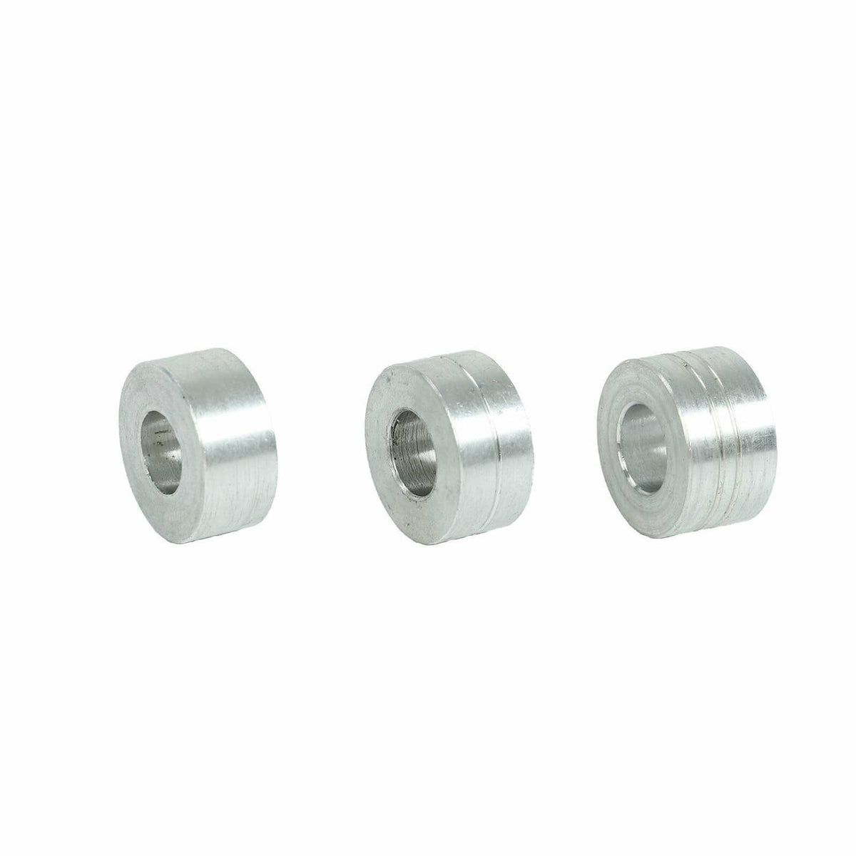 Three silver cylindrical spacers/bushings with inner hole, metal construction