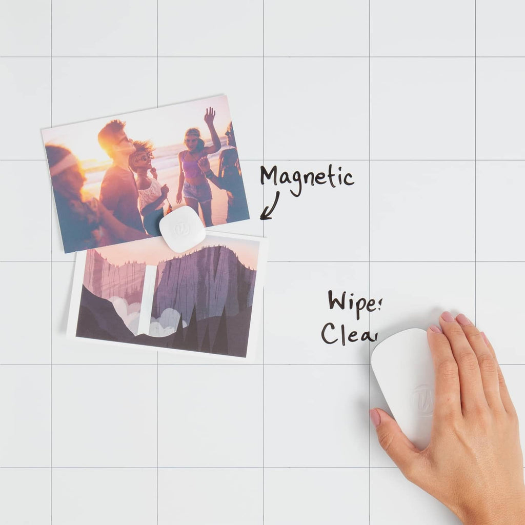 Magnetic whiteboard with silver frame and hand wiping the writing surface
