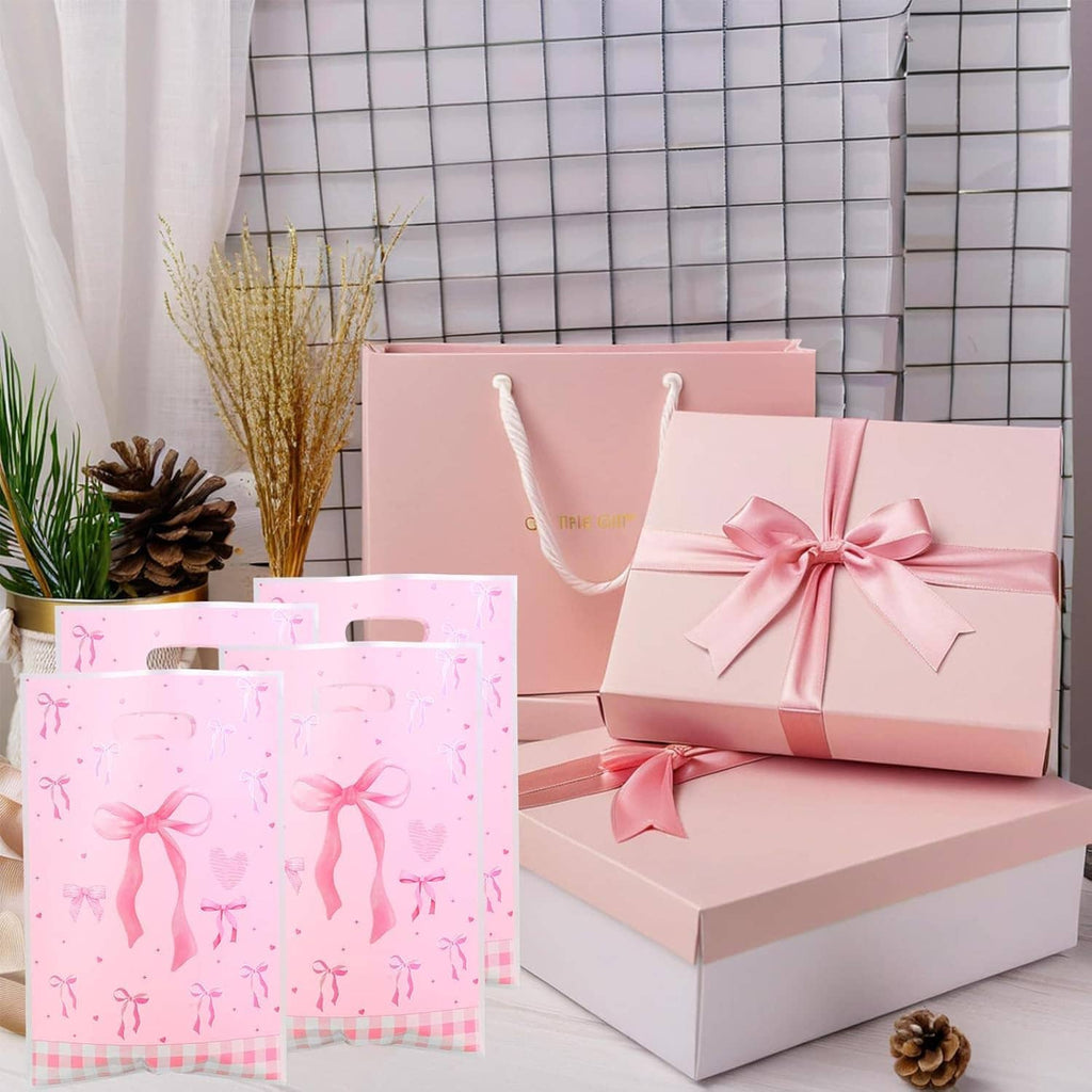 Pink bow gift bags with ribbon pattern, handle slot and stacked set