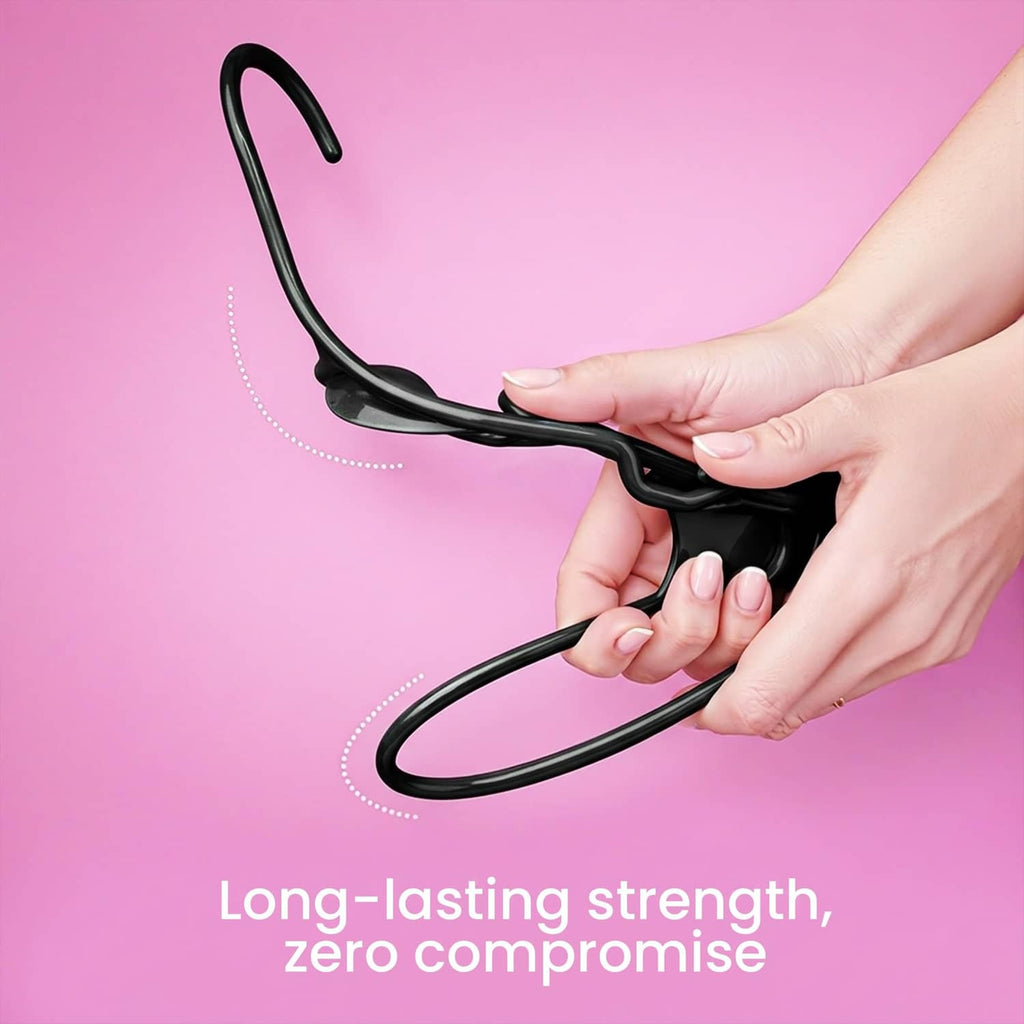 Black plastic hanger held by a hand, showing the hook and strong hanger frame.