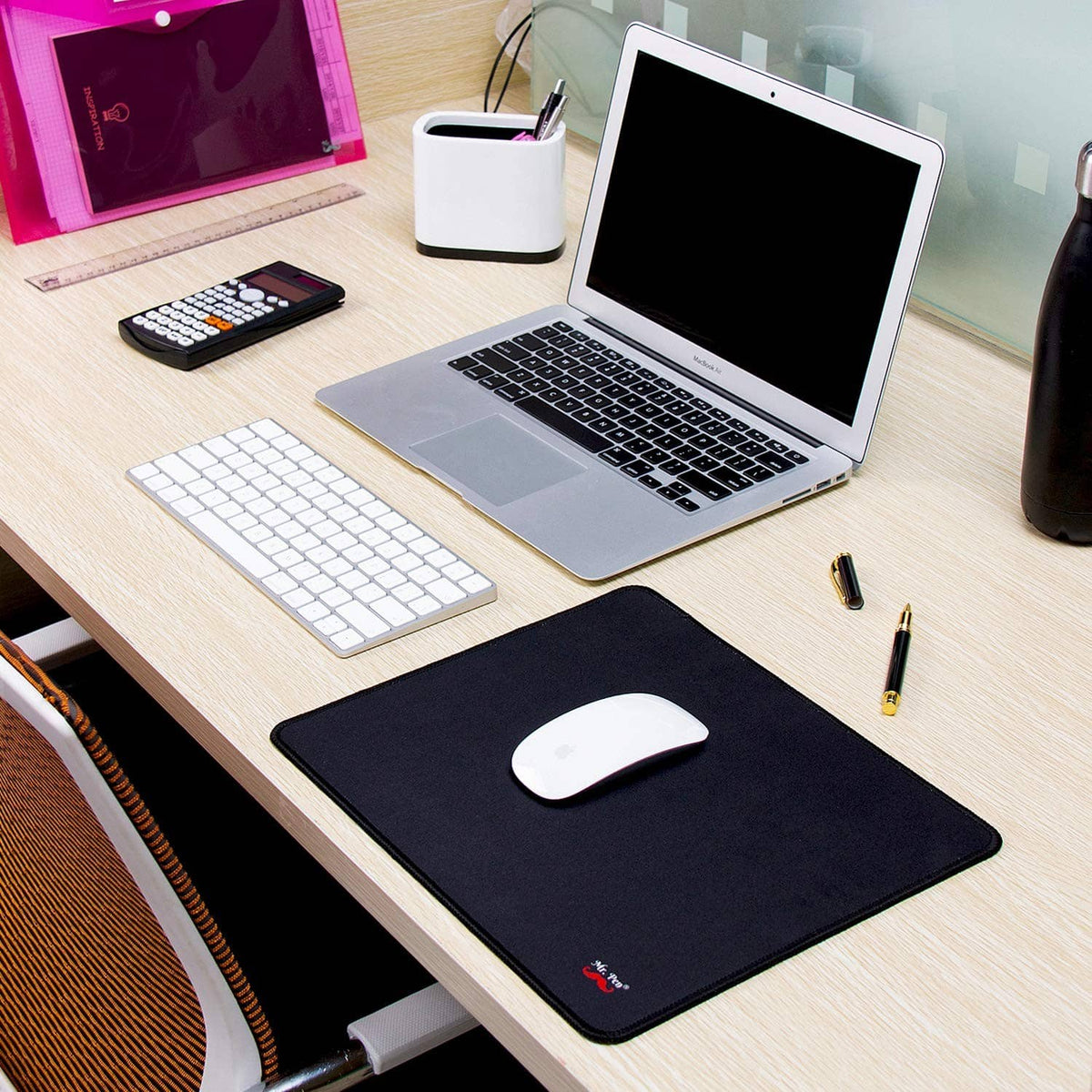 Black mouse pad with white optical mouse placed on the textured surface.