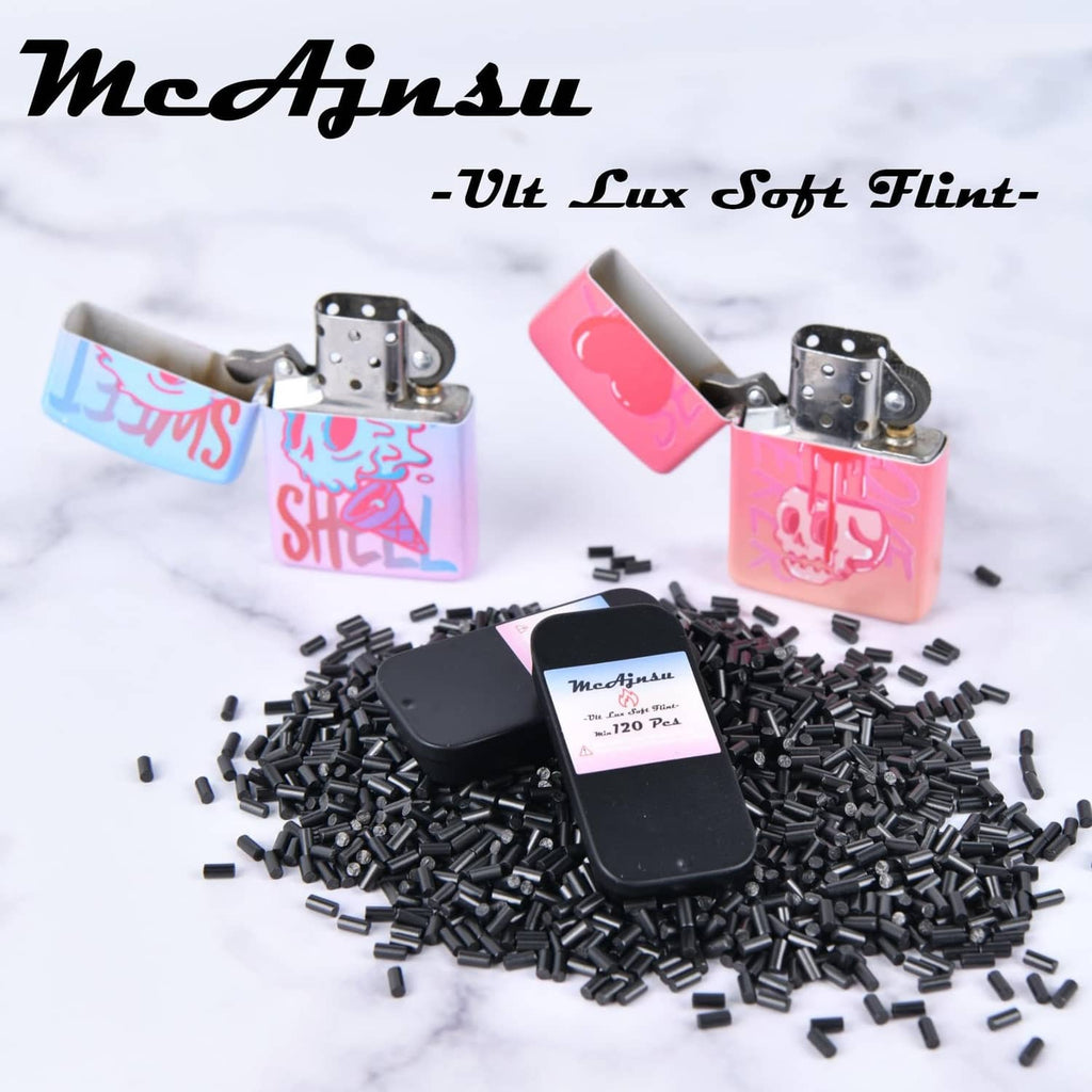 Universal lighter flint refill set with colorful cases and scattered black flint pieces