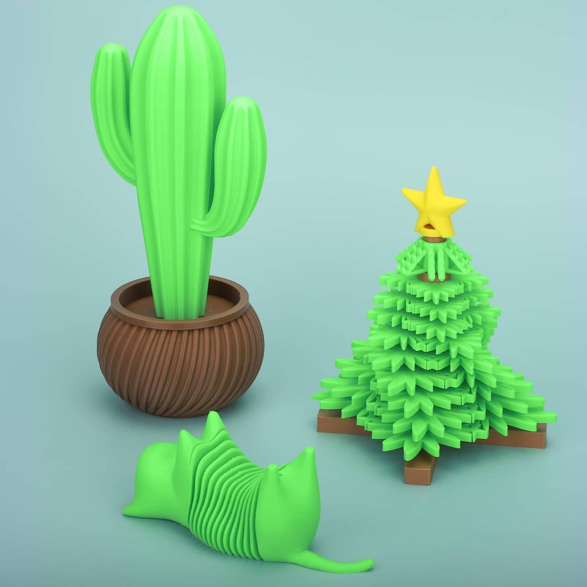 Green filament cactus models and a small tree figurine on brown bases