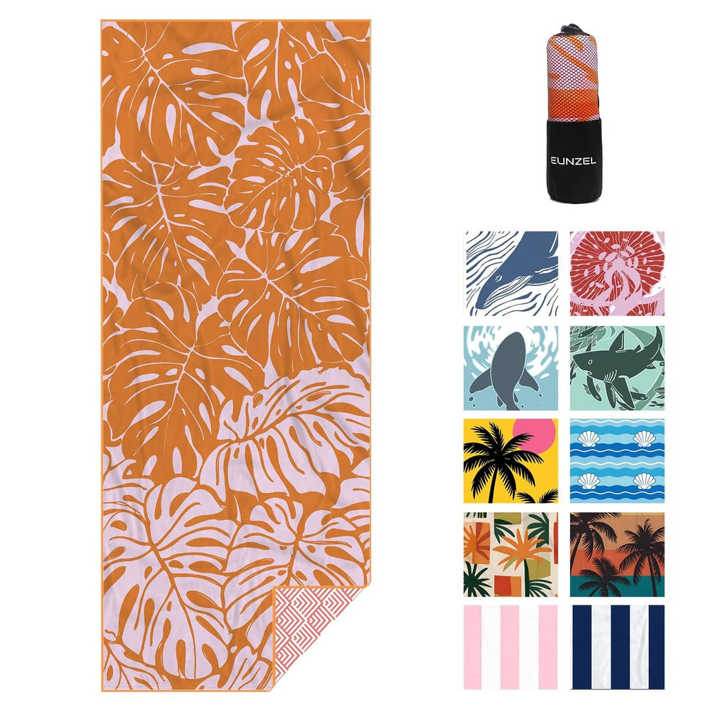 Orange beach towel with white palm leaf print, folded and in a zip pouch.