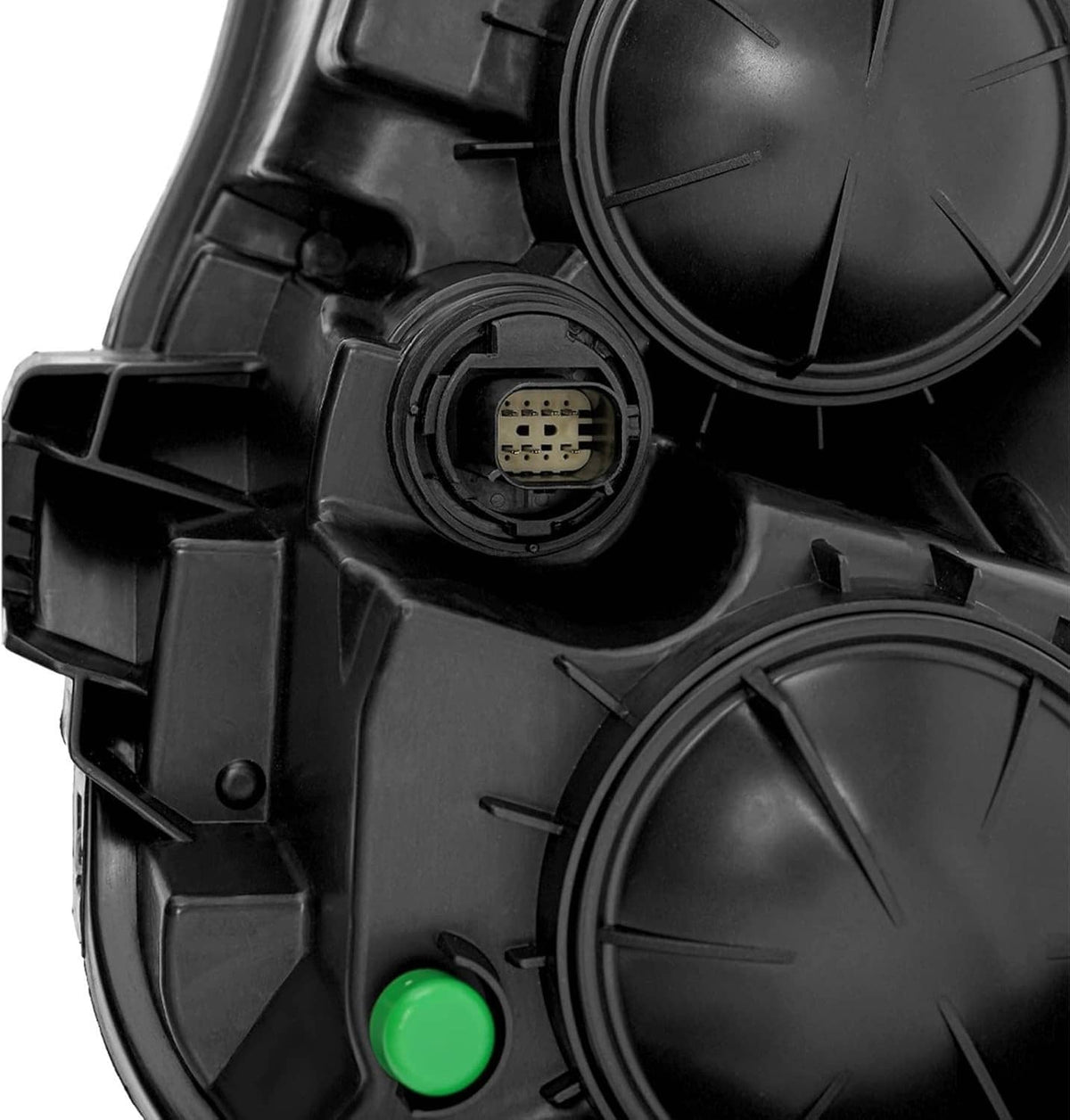 Left halogen headlight connector and wiring port with green circular markers, black housing close-up