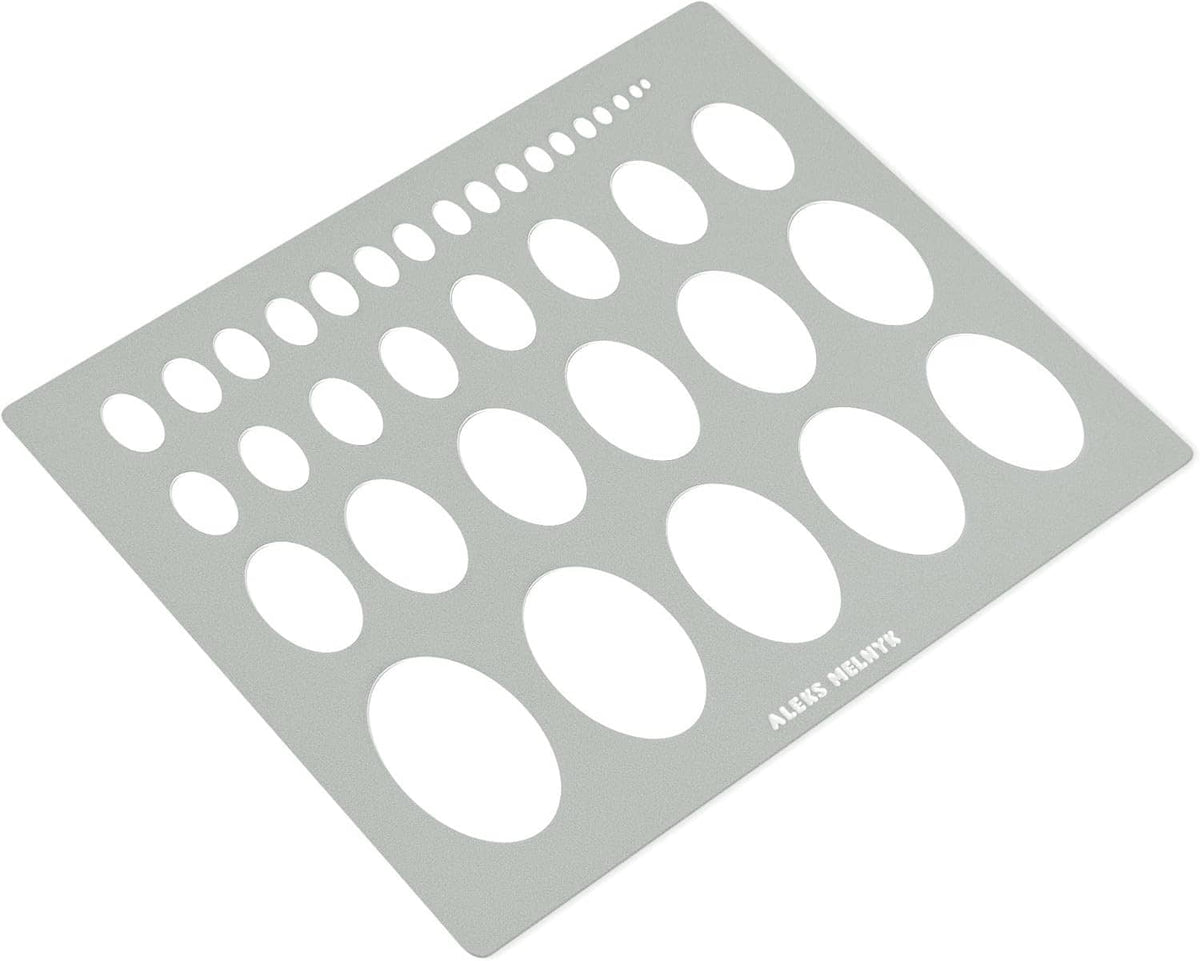 Geometric ellipse stencil template with oval cutouts on a gray metal sheet