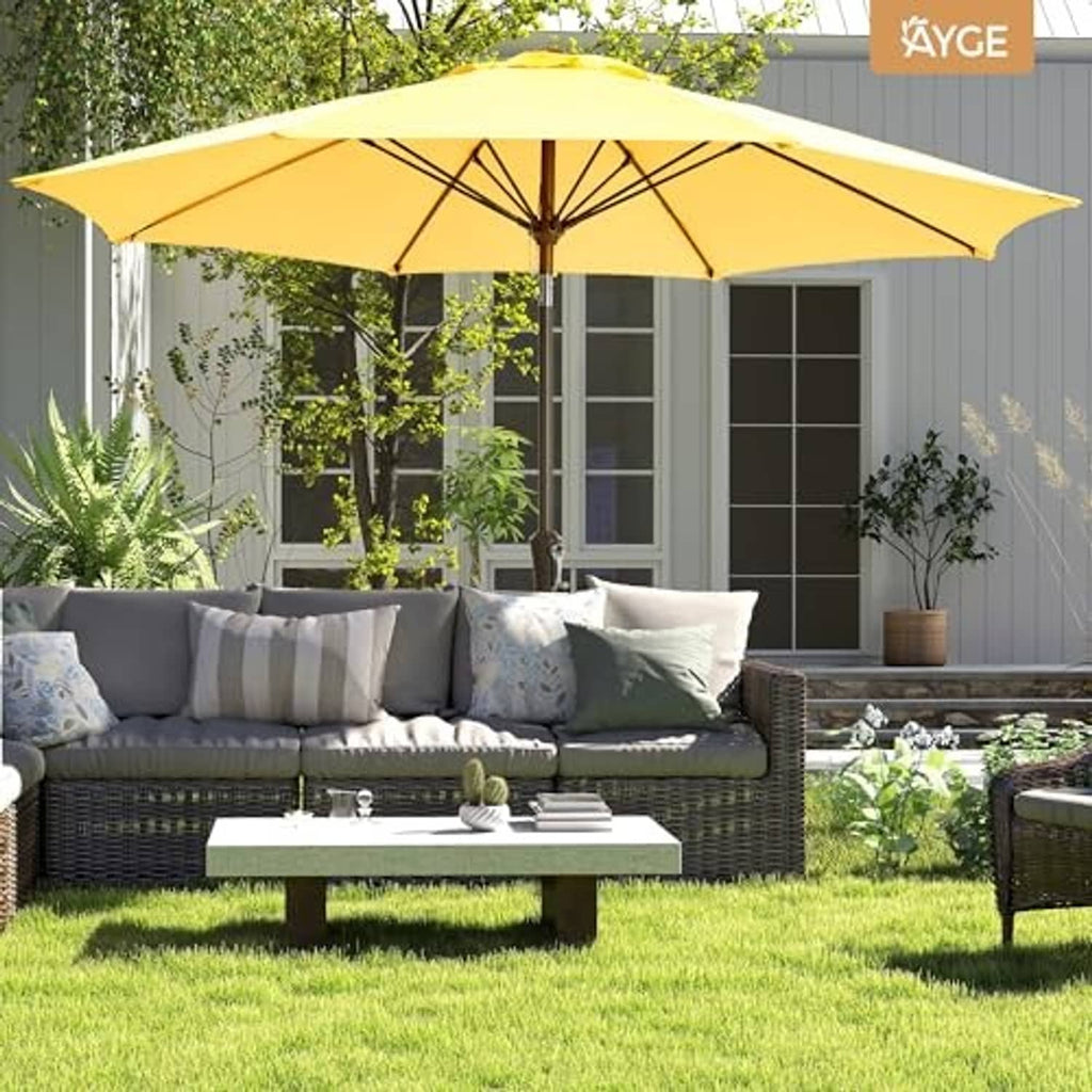 Yellow patio umbrella over backyard grass with open canopy and central pole