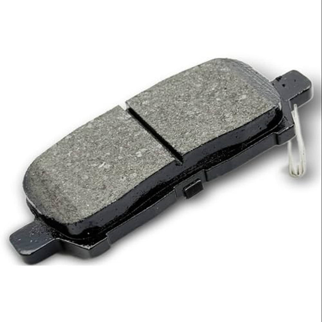 Ceramic brake pad with gray friction material and black backing, with metal clip detail.