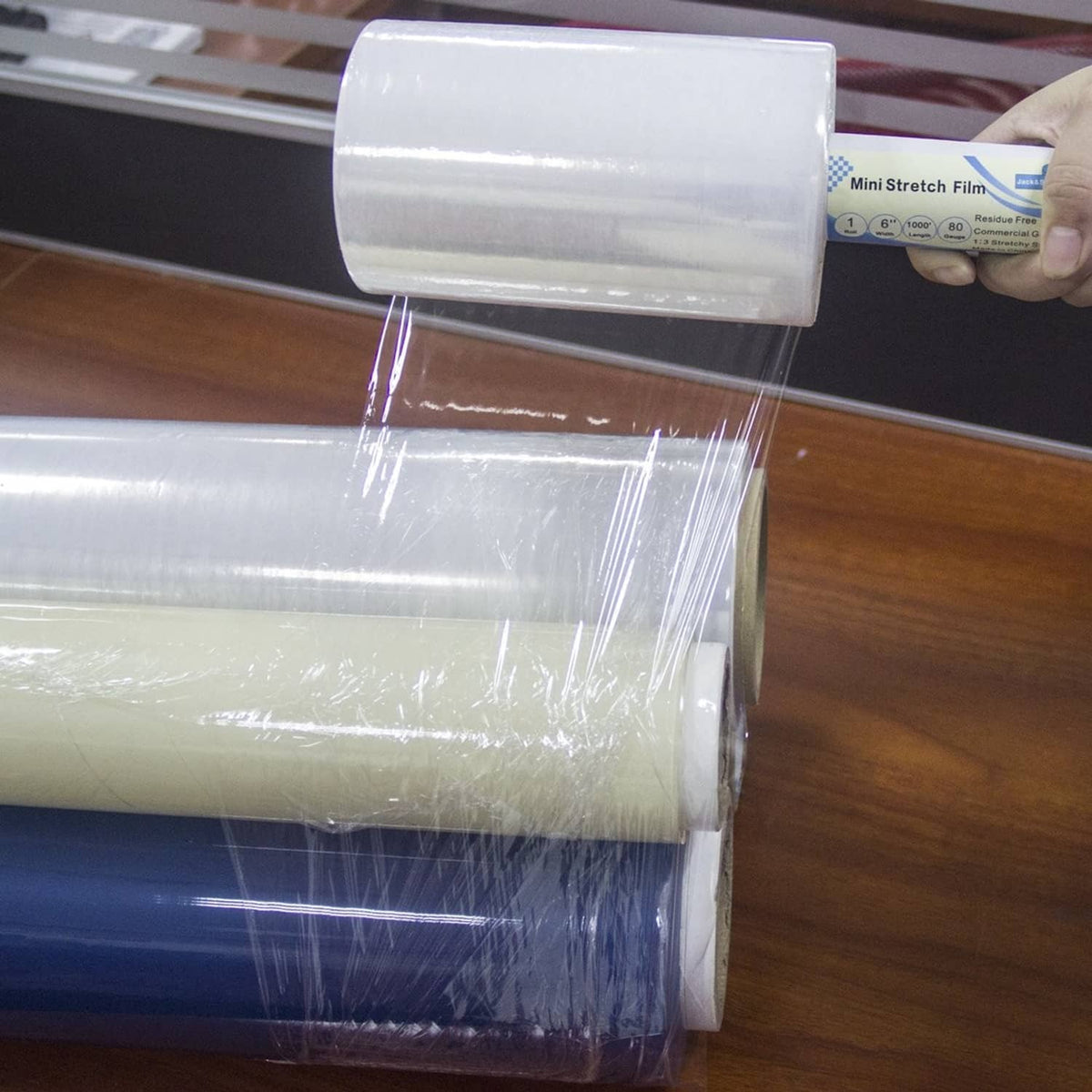 Transparent stretch wrap film pulled taut over stacked items