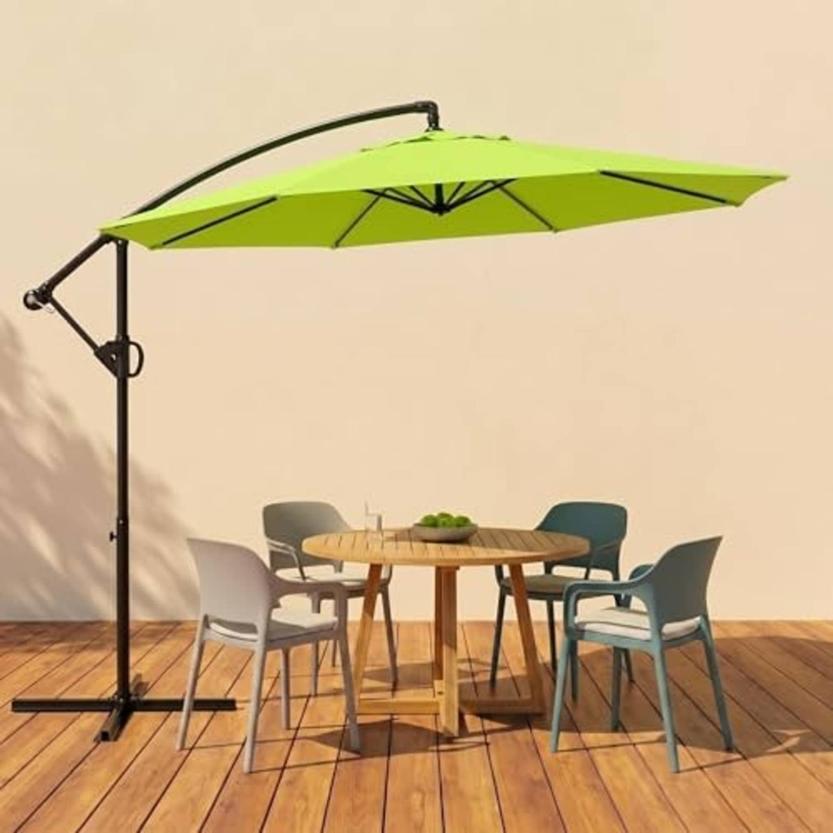 Green cantilever patio umbrella with offset black pole over outdoor table set