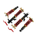Coilover suspension kit with red coil springs, black shocks, and mounting hardware