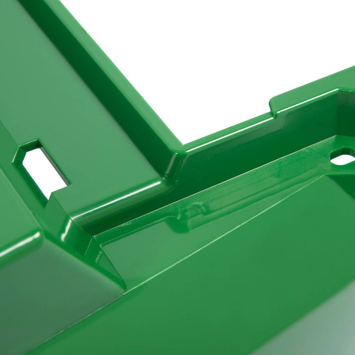 Close-up of green hood assembly seam, brackets, and mounting notch details.