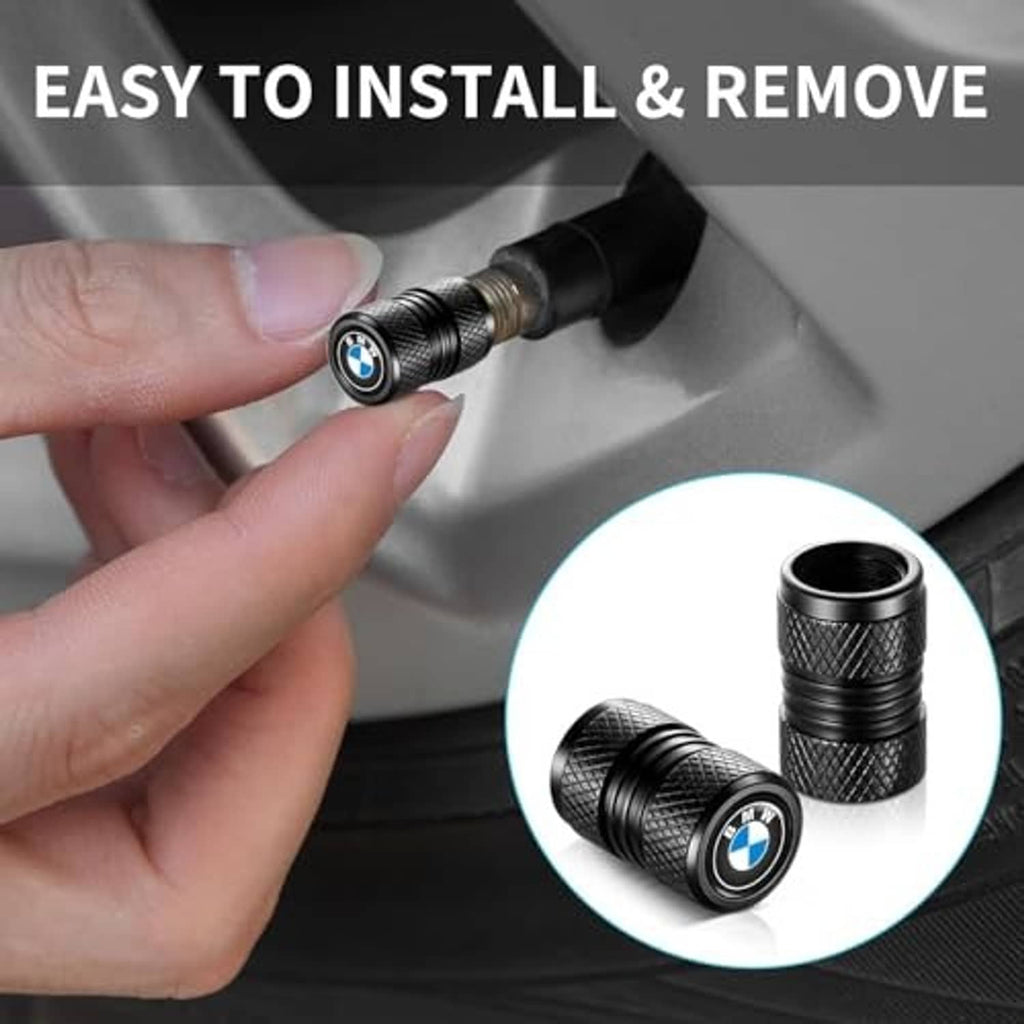 Hand installing a black textured valve stem cap with BMW logo on a tire valve