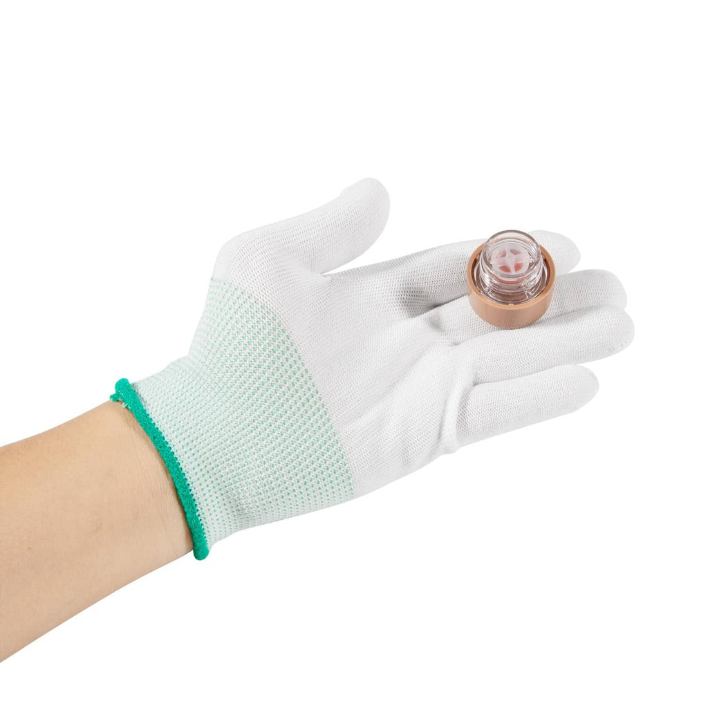 Hand wearing glove holding vacuum breaker float kit with brown cap and clear float