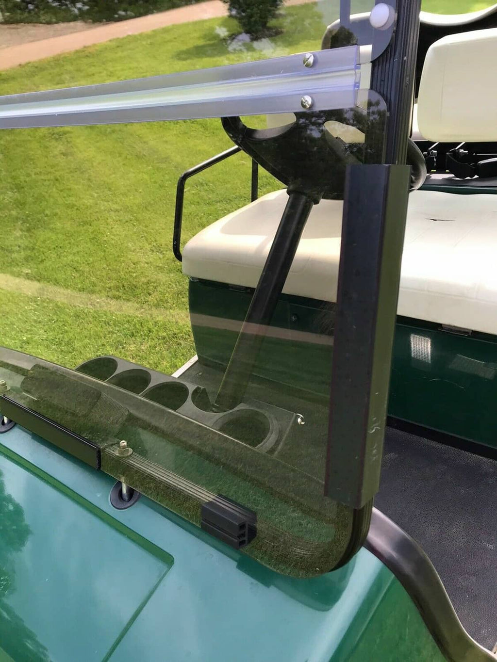 Tinted folding windshield side view with clear glass panels and metal frame