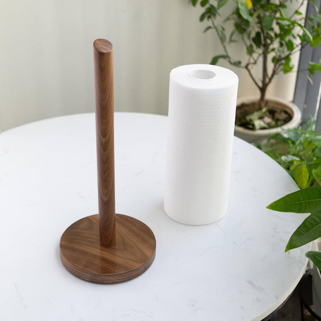 Dark walnut paper towel holder with round base, vertical pole, and white roll