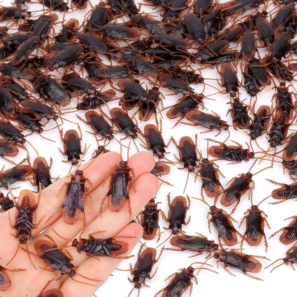 Pack of small dark fake insects scattered in a pile, assorted winged bug shapes
