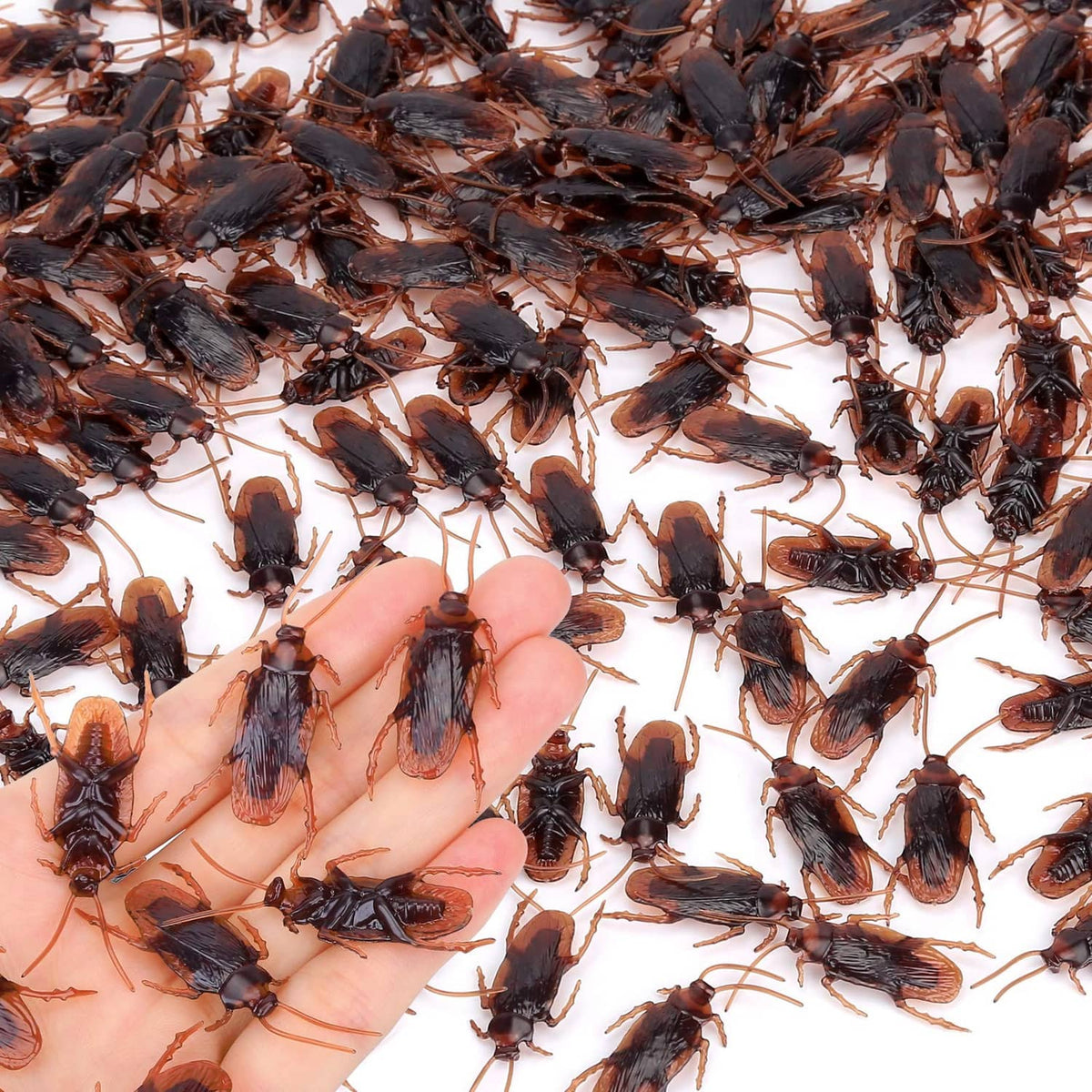 Pack of small dark fake insects scattered in a pile, assorted winged bug shapes