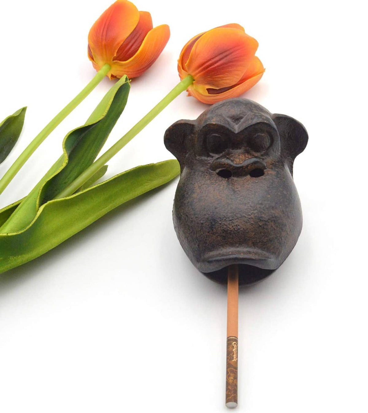 Dark monkey cast ashtray on a cigarette-style holder, open top