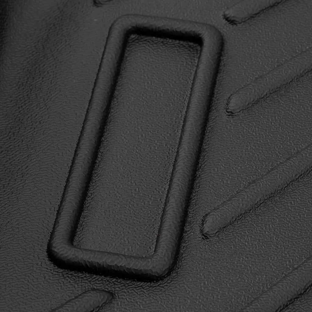Close-up of black floor mat molded cutout section with raised border