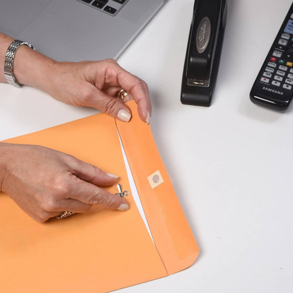 Kraft brown gummed clasp envelope being sealed by hand