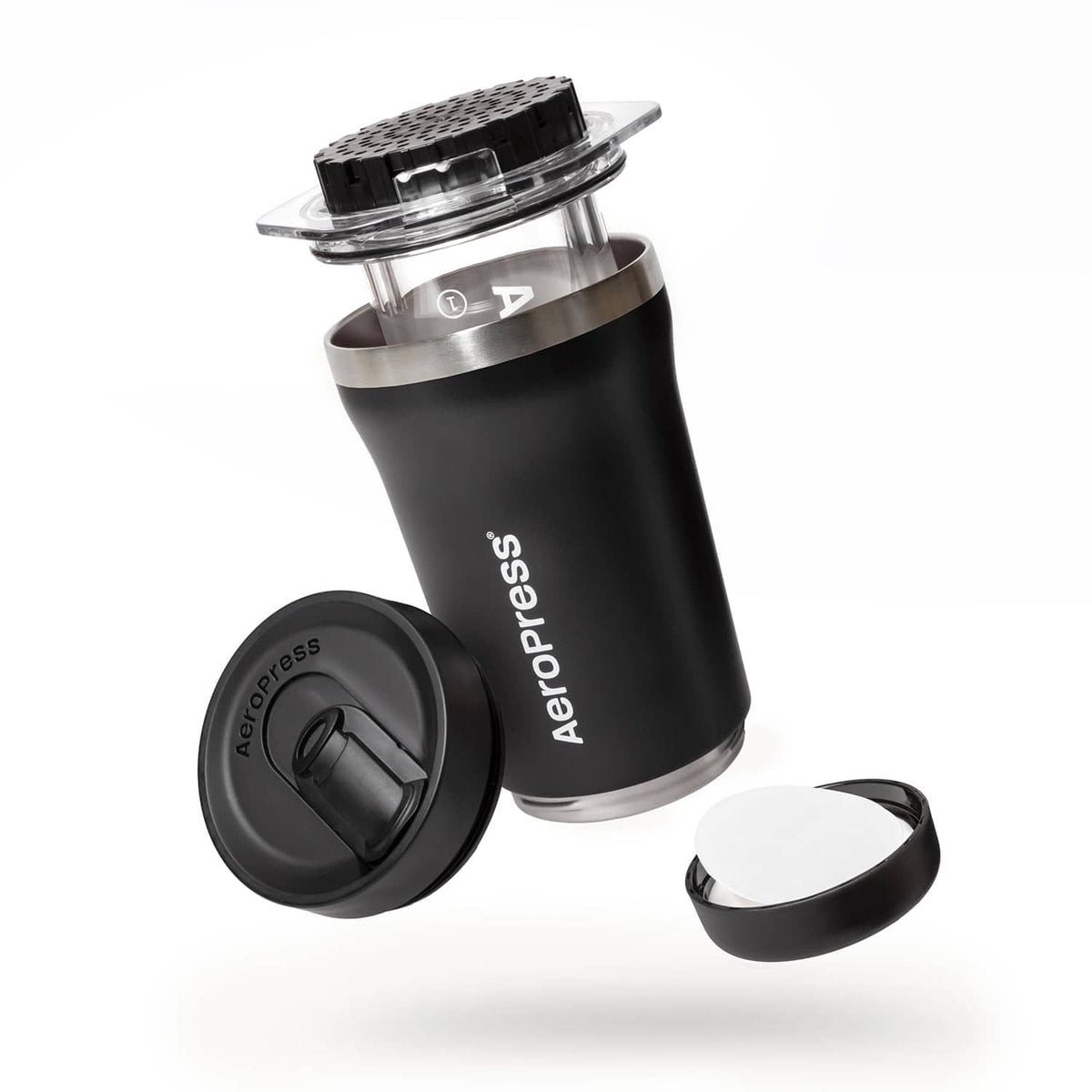 Black AeroPress coffee maker body with clear brewing top and detachable lid parts.