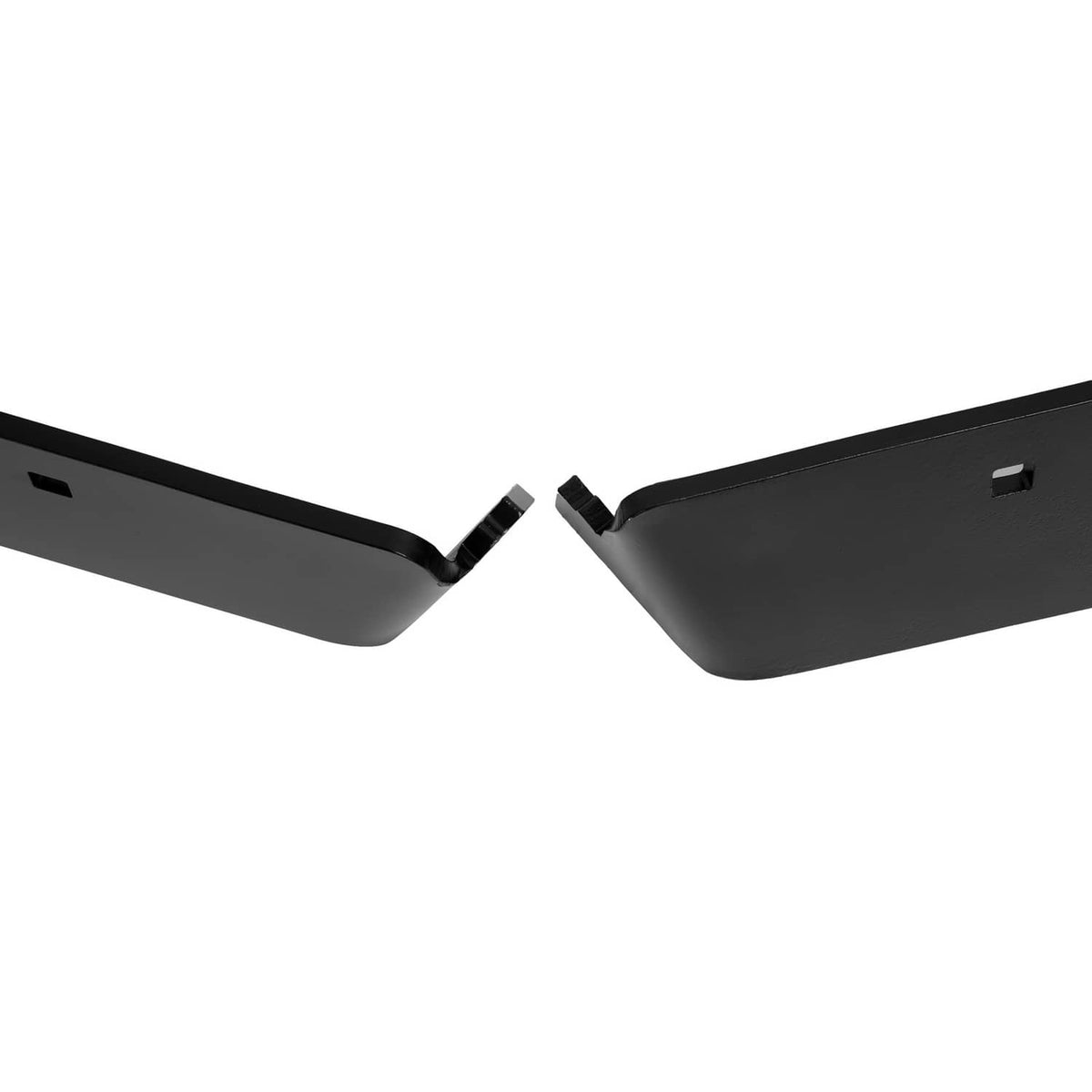 Close view of two black snow plow cutting edge blades meeting at the center gap
