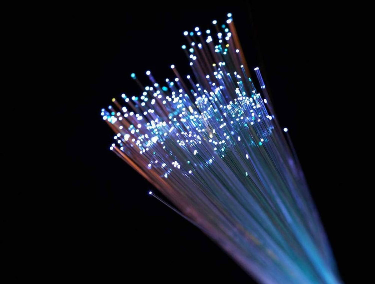 Blue glowing fiber optic strands with starburst end tips, angled burst