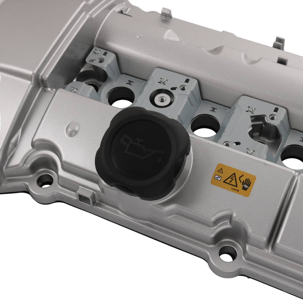 Valve cover interior close-up with black oil cap and molded component plugs
