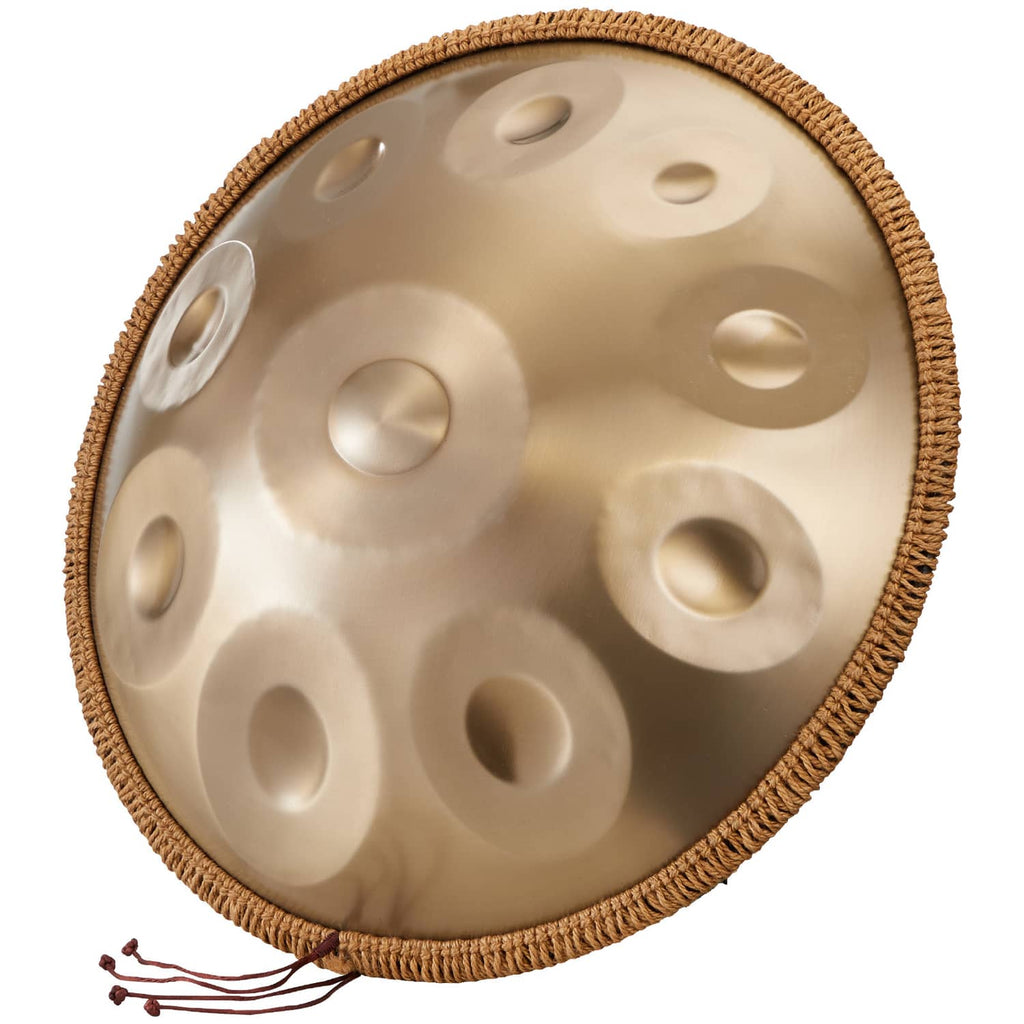 Close-up golden handpan drum tone surface with raised note dimples and rope edge