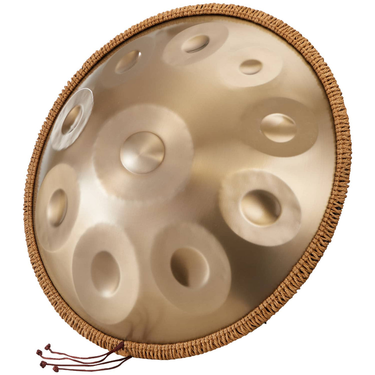 Close-up golden handpan drum tone surface with raised note dimples and rope edge