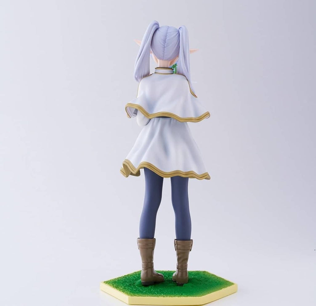 Back-view character figurine with lavender ponytail, white dress with gold trim, green base.