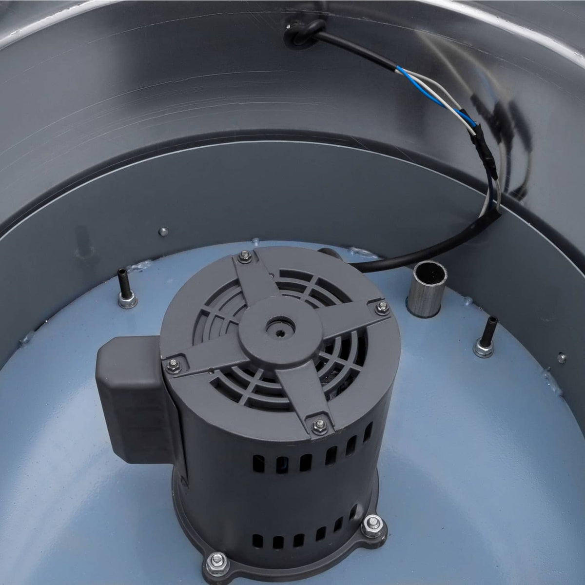 Down-blast exhaust fan motor and fan wheel inside stainless housing.