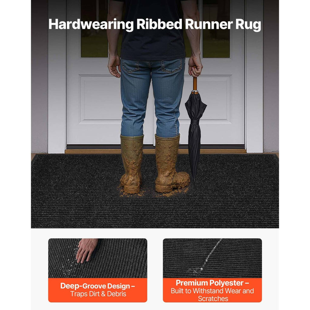 Dark ribbed runner rug with low pile texture, shown at doorway with boots