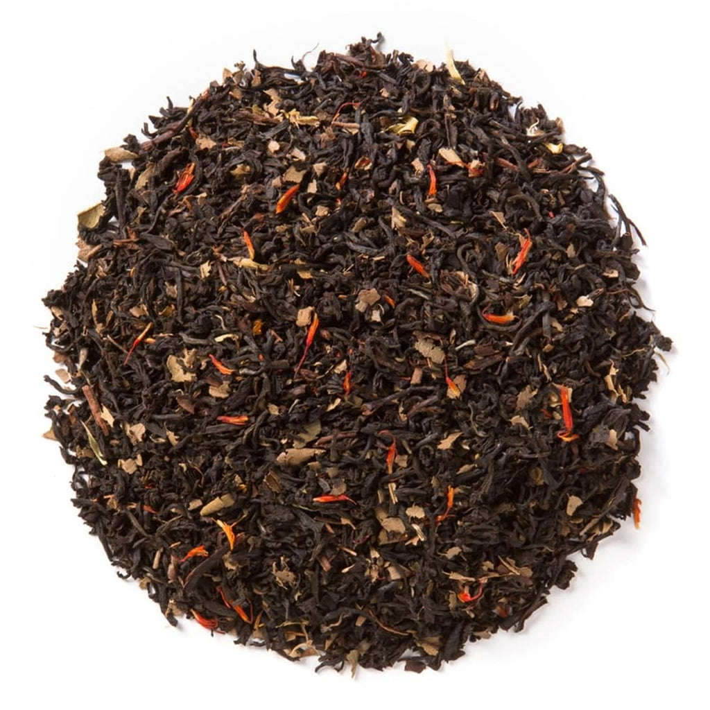 Loose leaf organic black tea in a heap with small orange and brown pieces