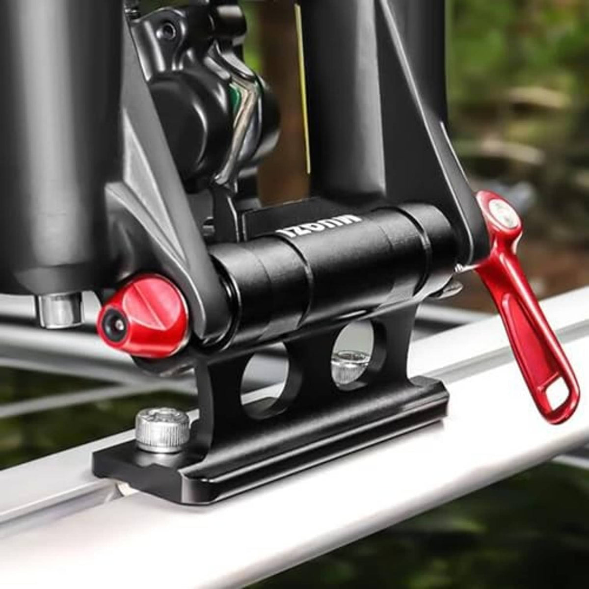 Bike fork support on car roof rack with red lever and black mounting bracket