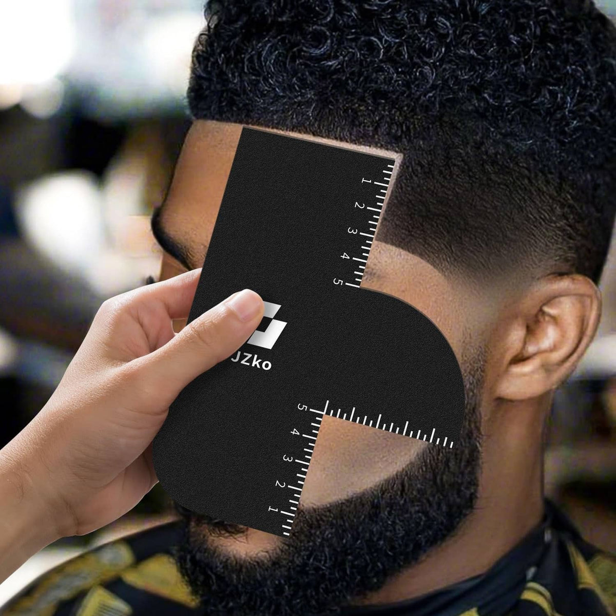 Black hairline shaping card with ruler held against beard and side hairline