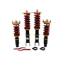 Coilover suspension kit with red springs, black shocks, gold top plates and mounting hardware