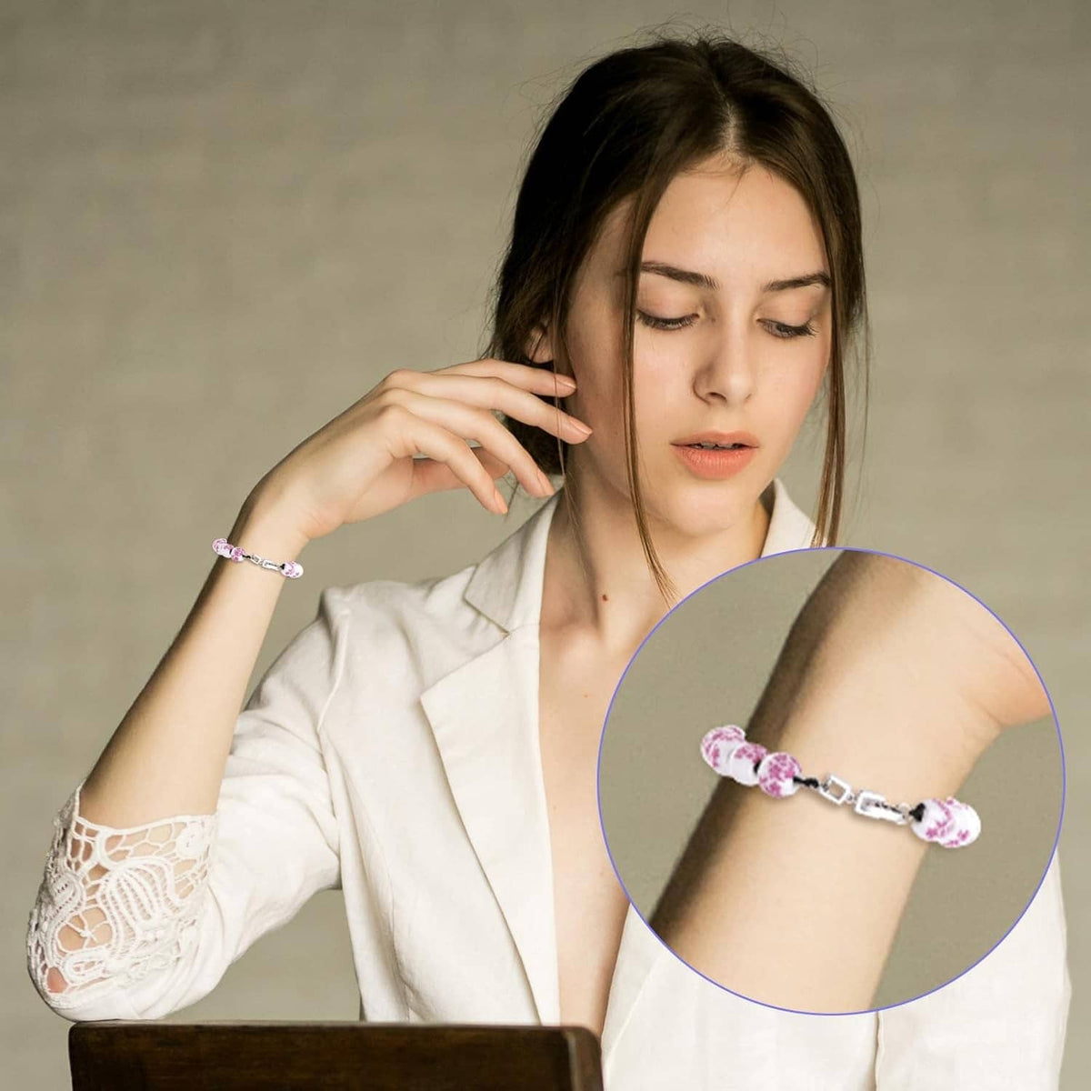 Silver fold-over clasp extender bracelet on wrist with linked ball beads
